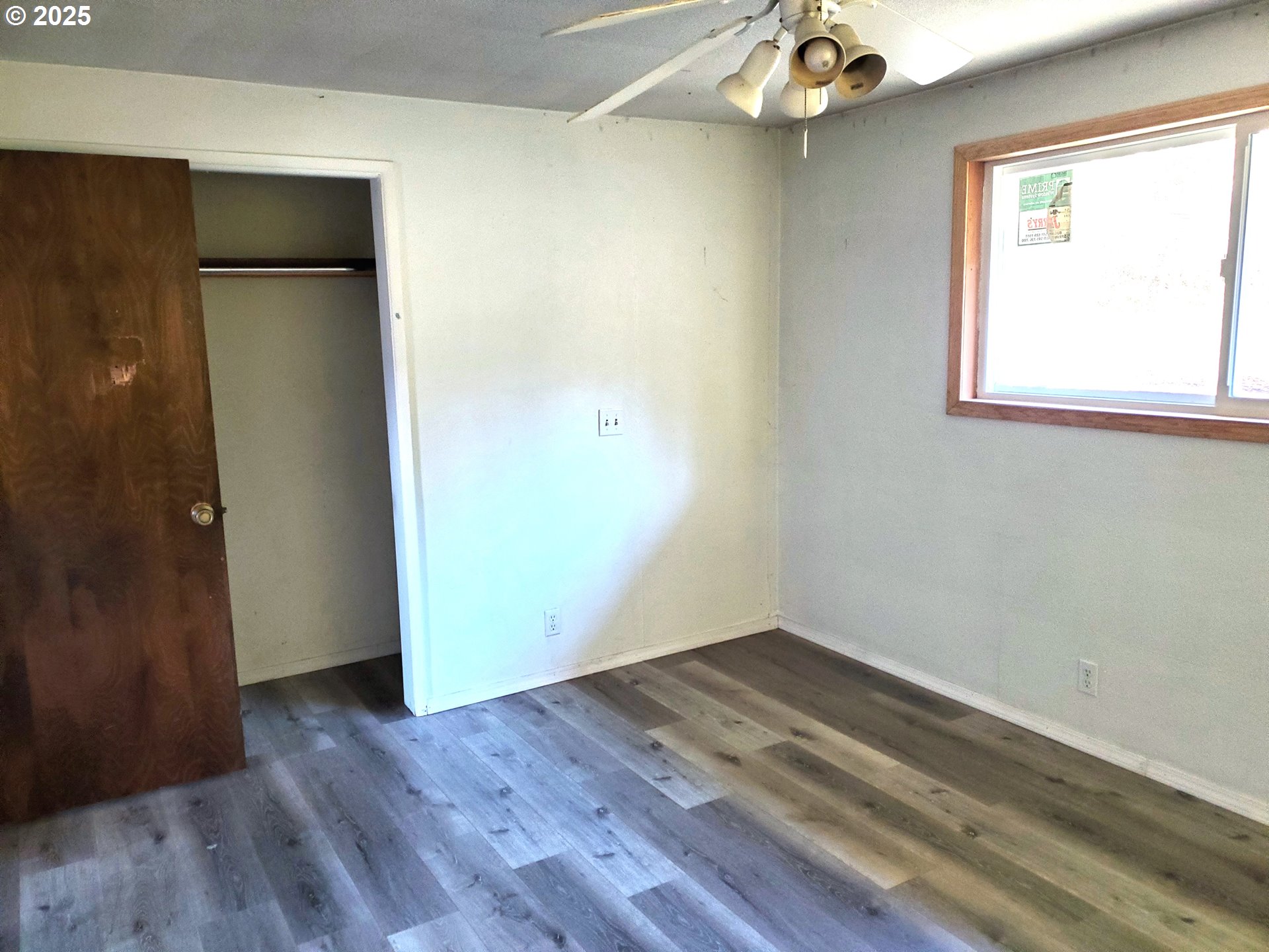 37186 Tree Farm Road Springfield, OR 97478 - Photo 14 of 37 an empty room with wooden floor and a window