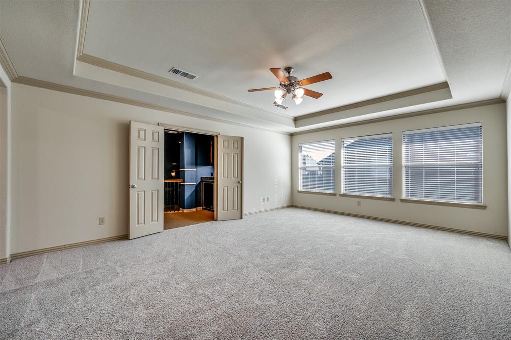1318 Rio Grande Drive Allen, TX 75013 - Photo 22 of 38 a view of an empty room with a window and a kitchen