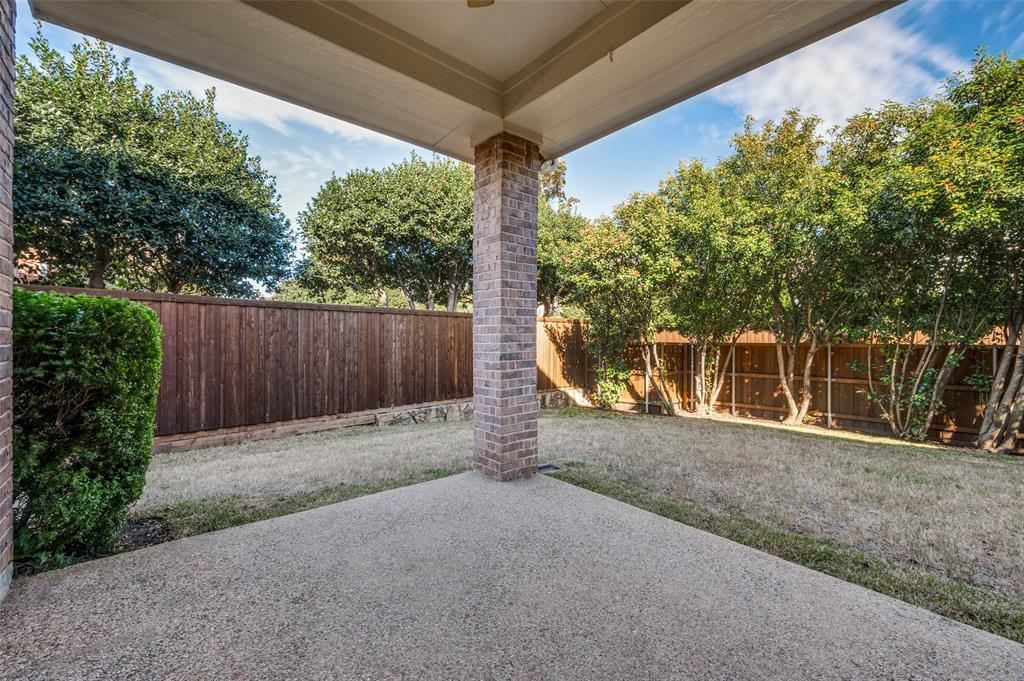 1318 Rio Grande Drive Allen, TX 75013 - Photo 29 of 38 a backyard of a house with a large tree and wooden fence