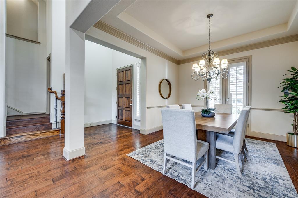 1318 Rio Grande Drive Allen, TX 75013 - Photo 6 of 38 a view of a dining room with furniture a chandelier and wooden floor