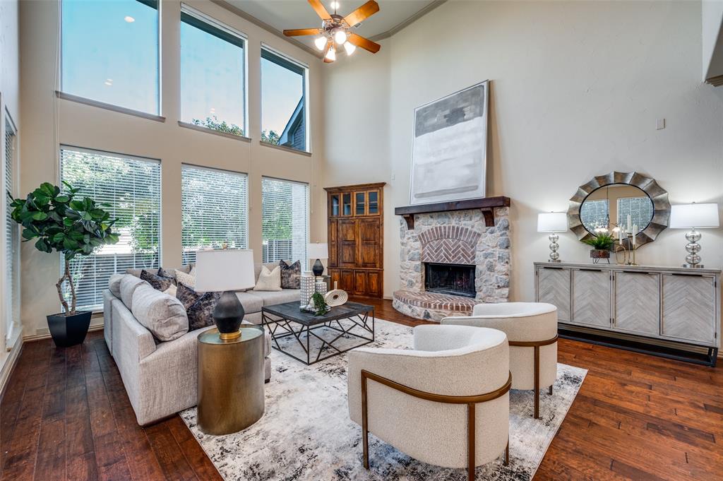 1318 Rio Grande Drive Allen, TX 75013 - Photo 9 of 38 a living room with furniture a fireplace and potted plants