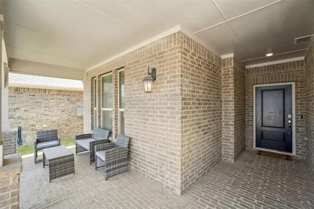 a balcony with furniture and a gate