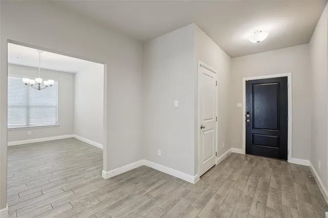 an empty room with closet and wooden floor