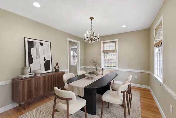 a view of a a dining room with furniture window and wooden floor
