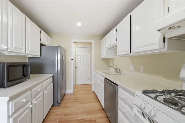 a kitchen with stainless steel appliances a stove a sink and a refrigerator