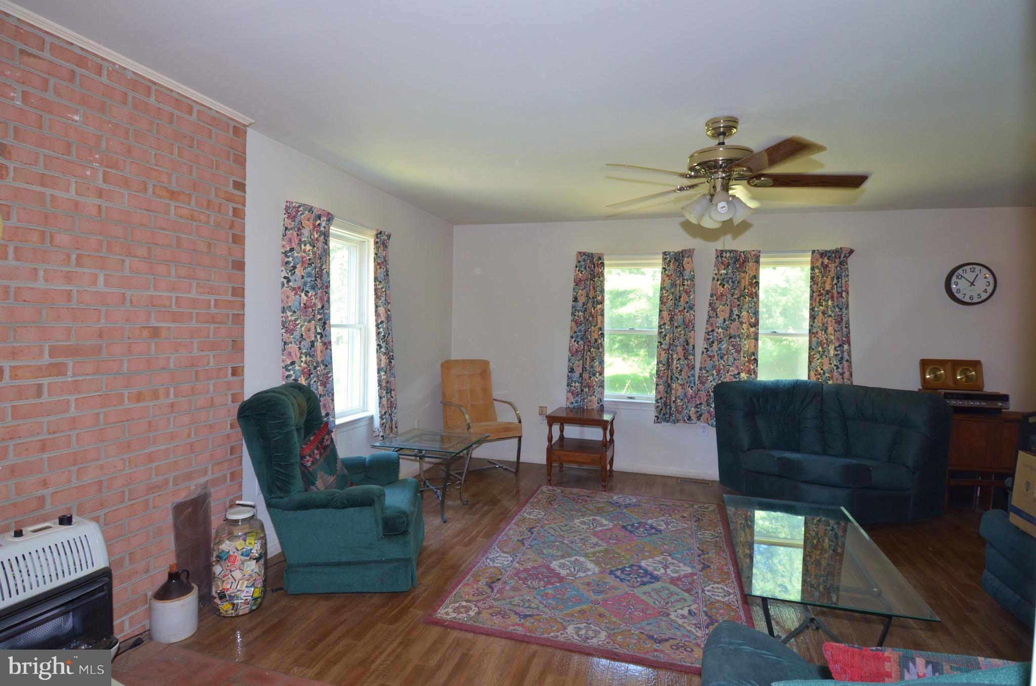 764 Summit Point Road Summit Point, WV 25446 - Photo 8 of 23 Living room with propane heater.