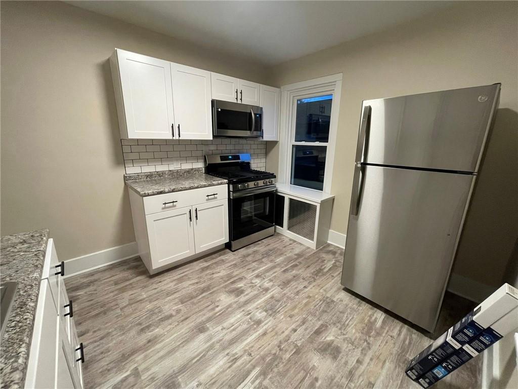 863 5th Avenue, Unit 2 Coraopolis, PA 15108 - Photo 2 of 17 a kitchen with a refrigerator sink and microwave
