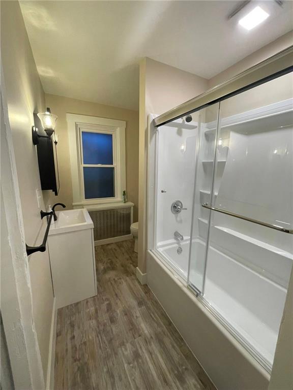 863 5th Avenue, Unit 2 Coraopolis, PA 15108 - Photo 8 of 17 a bathroom with a tub and a glass door shower