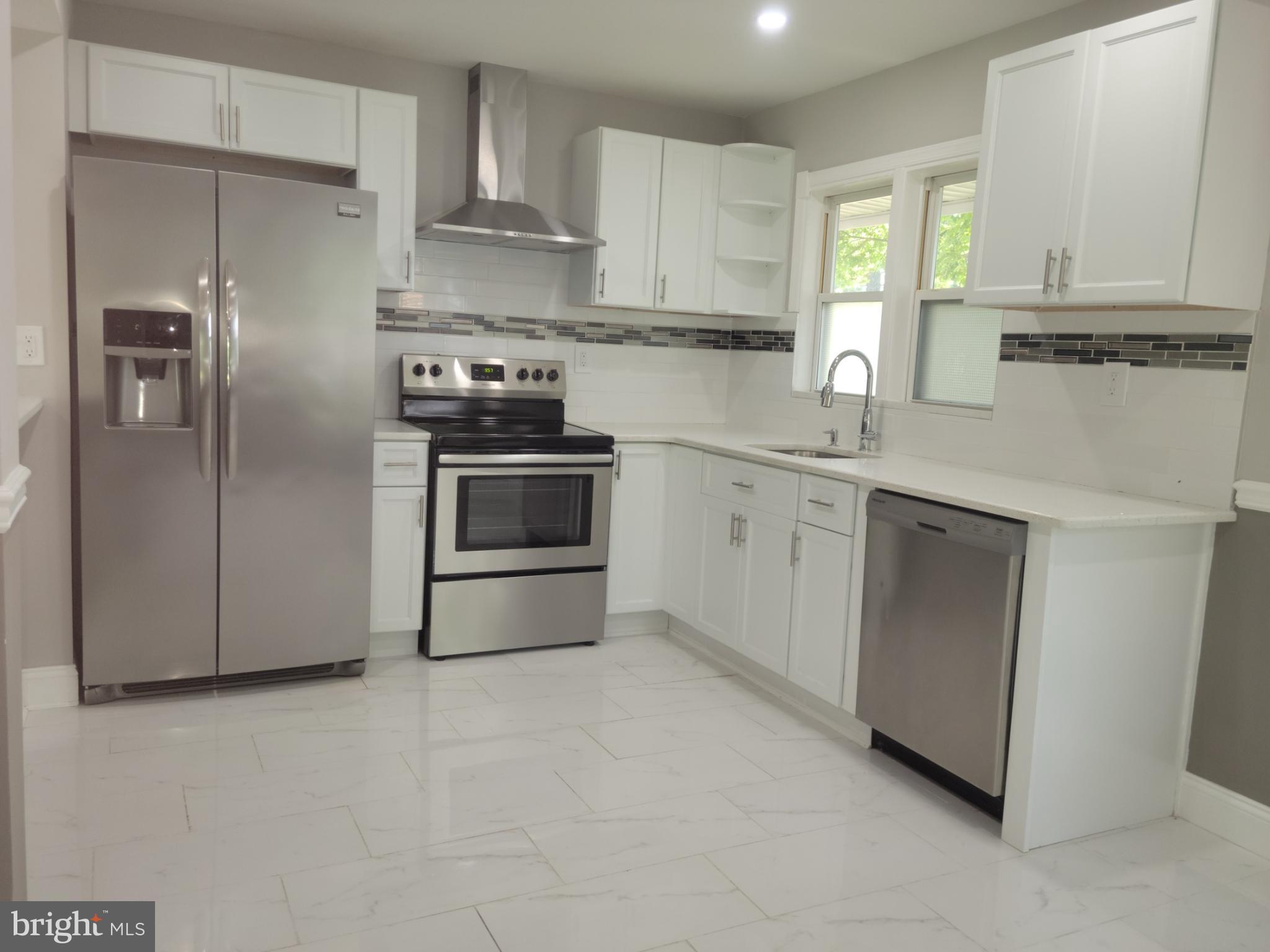 169 Sunset Road Willingboro, NJ 08046 - Photo 3 of 26 a kitchen with stainless steel appliances white cabinets and a sink