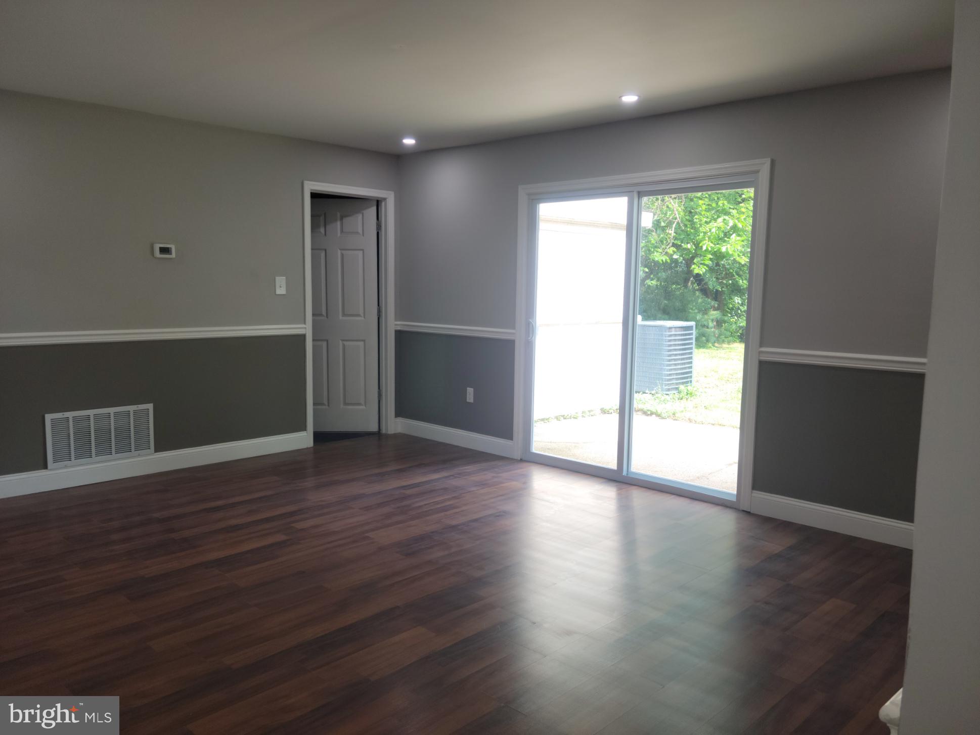 169 Sunset Road Willingboro, NJ 08046 - Photo 8 of 26 a view of an empty room with wooden floor and a window
