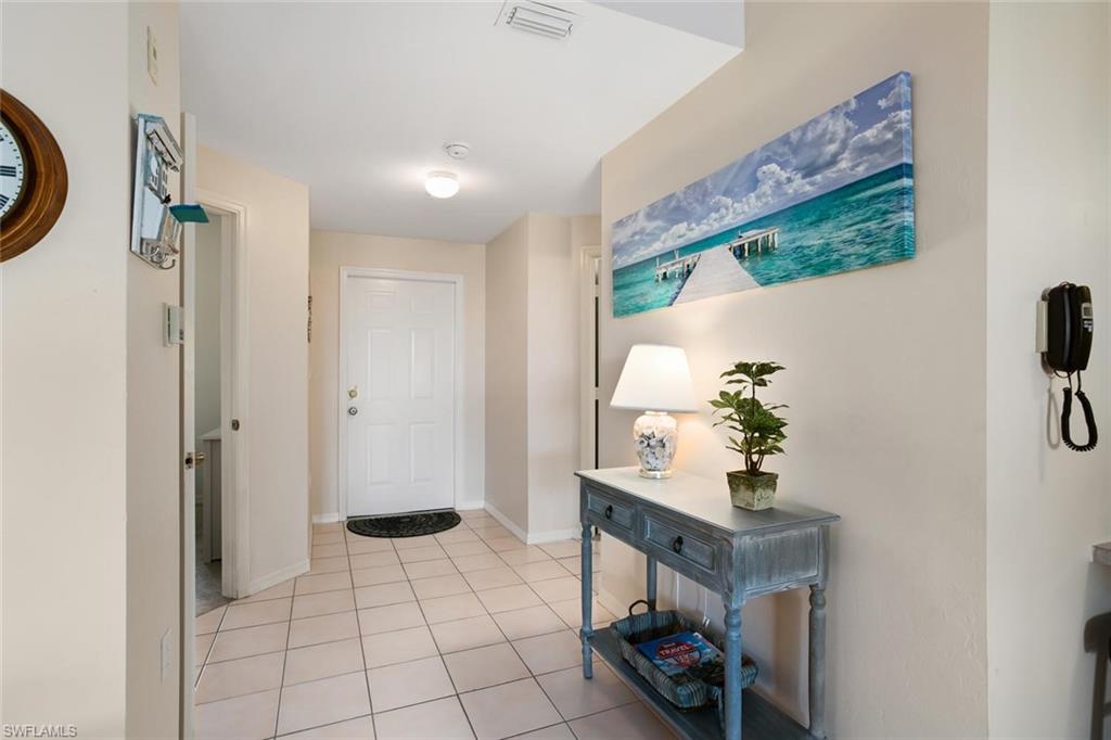 519 Roma Court, Unit 306 Naples, FL 34110 - Photo 3 of 15 a living room with furniture and a flat screen tv