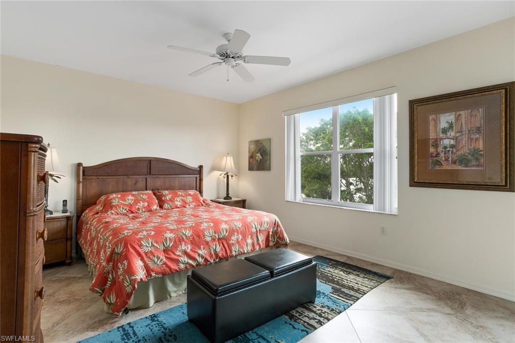 519 Roma Court, Unit 306 Naples, FL 34110 - Photo 8 of 15 a bedroom with a bed and wooden floor