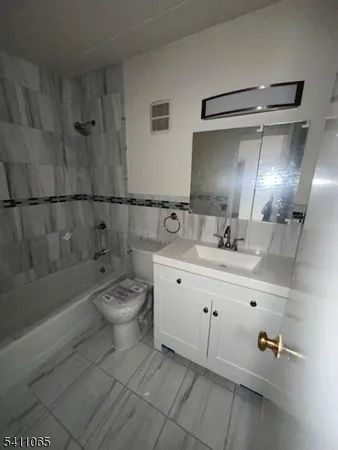 a bathroom with a double vanity sink toilet and shower
