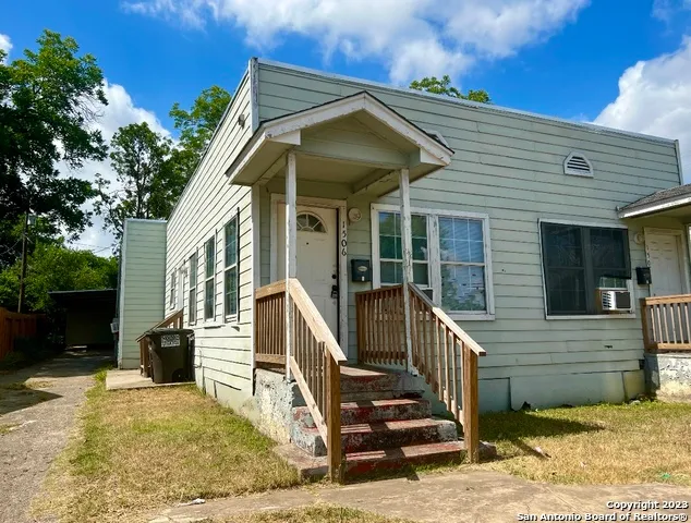 a view of a house with wooden fence