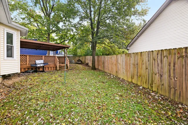 a backyard of a house with table and chairs