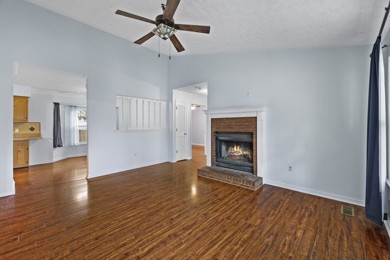 400 Hickory Timber Court Antioch, TN 37013 - Photo 6 of 38 a view of empty room with wooden floor and fireplace