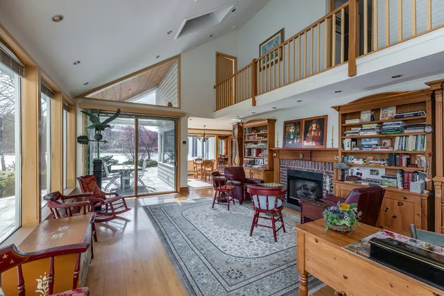 a view of a hallway with wooden floor and stairs