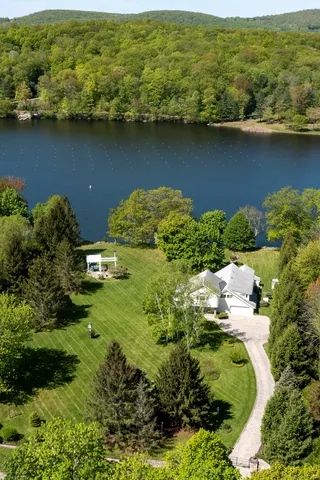 an aerial view of a houses with a lake view