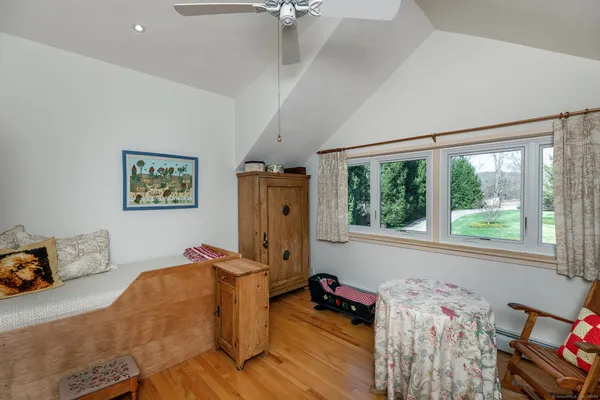 a bedroom with a bed and a flat tv screen on the dresser