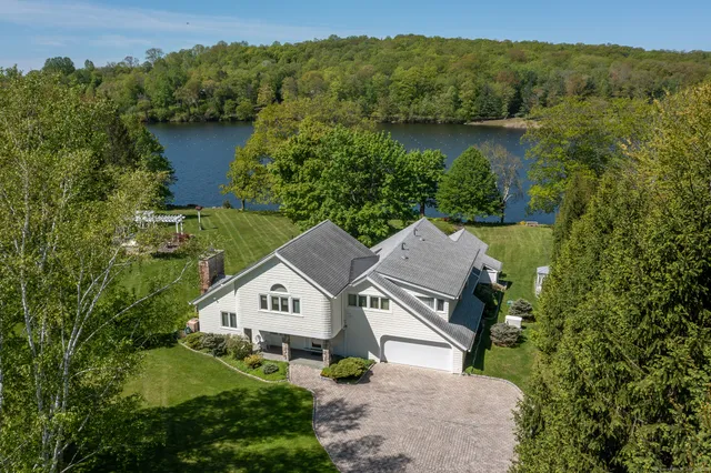 an aerial view of a house with a garden and a yard