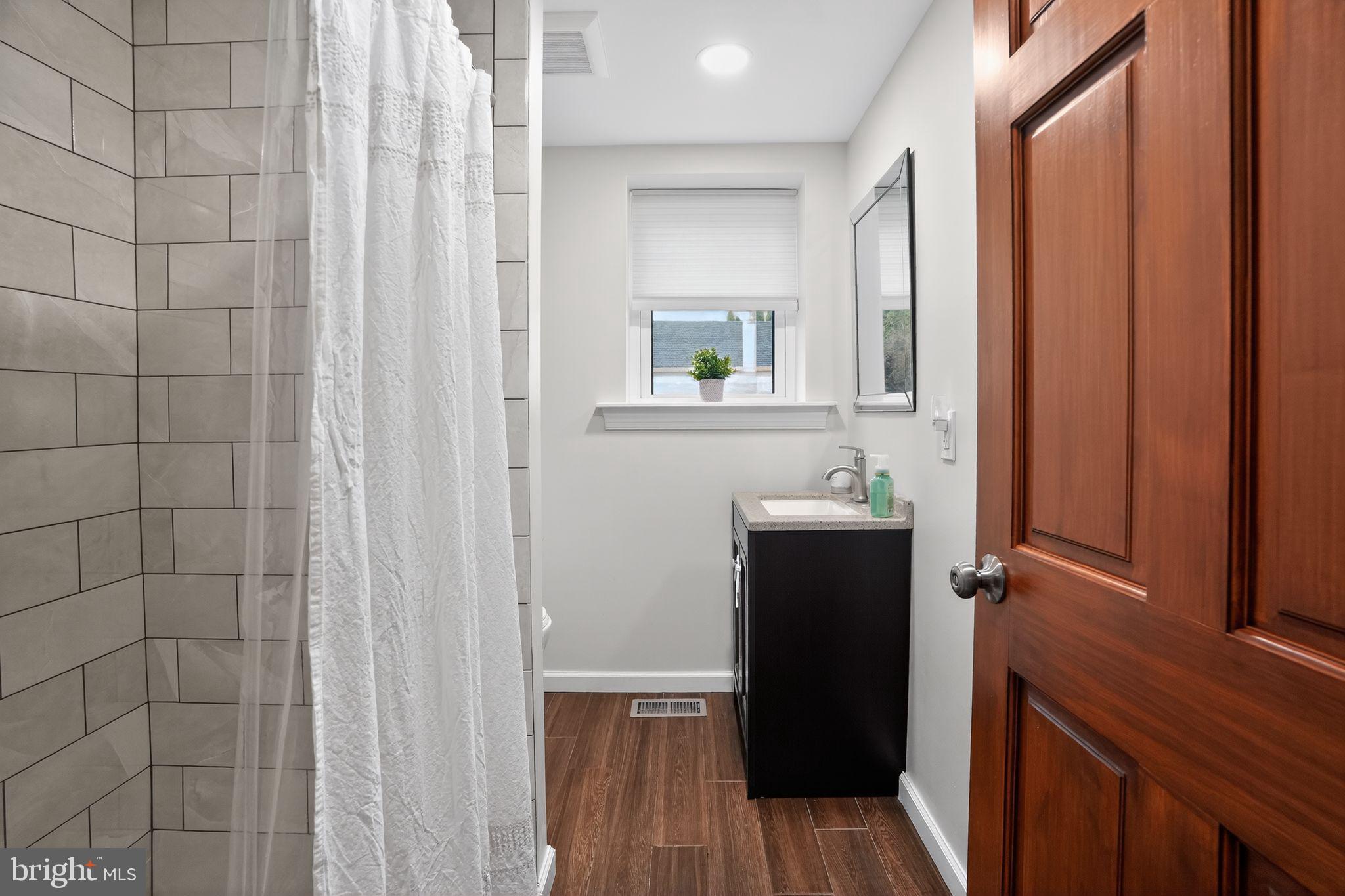 516 Church Road Norristown, PA 19403 - Photo 23 of 31 a bathroom with a sink and a mirror
