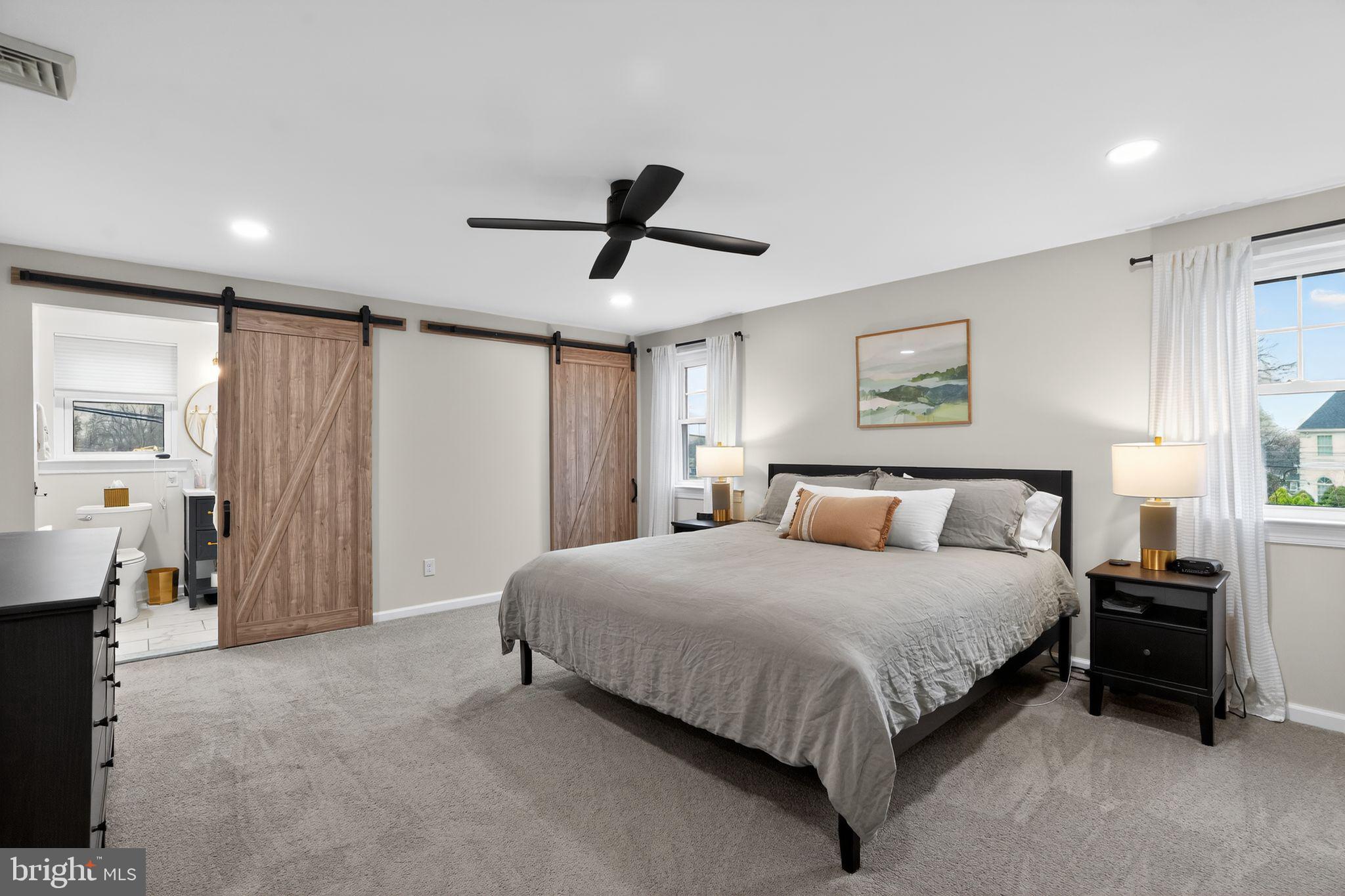 516 Church Road Norristown, PA 19403 - Photo 24 of 31 a spacious bedroom with a bed and a chandelier
