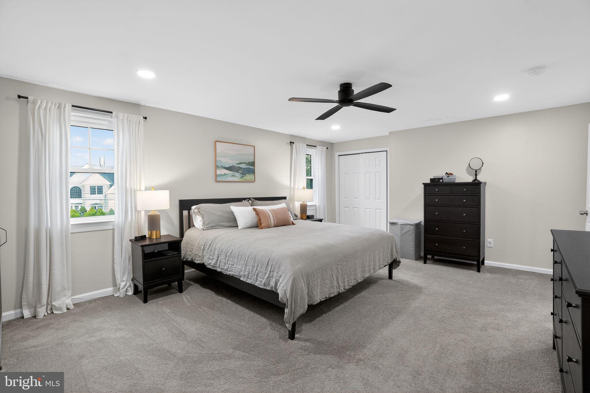 516 Church Road Norristown, PA 19403 - Photo 25 of 31 a spacious bedroom with a bed and a chandelier