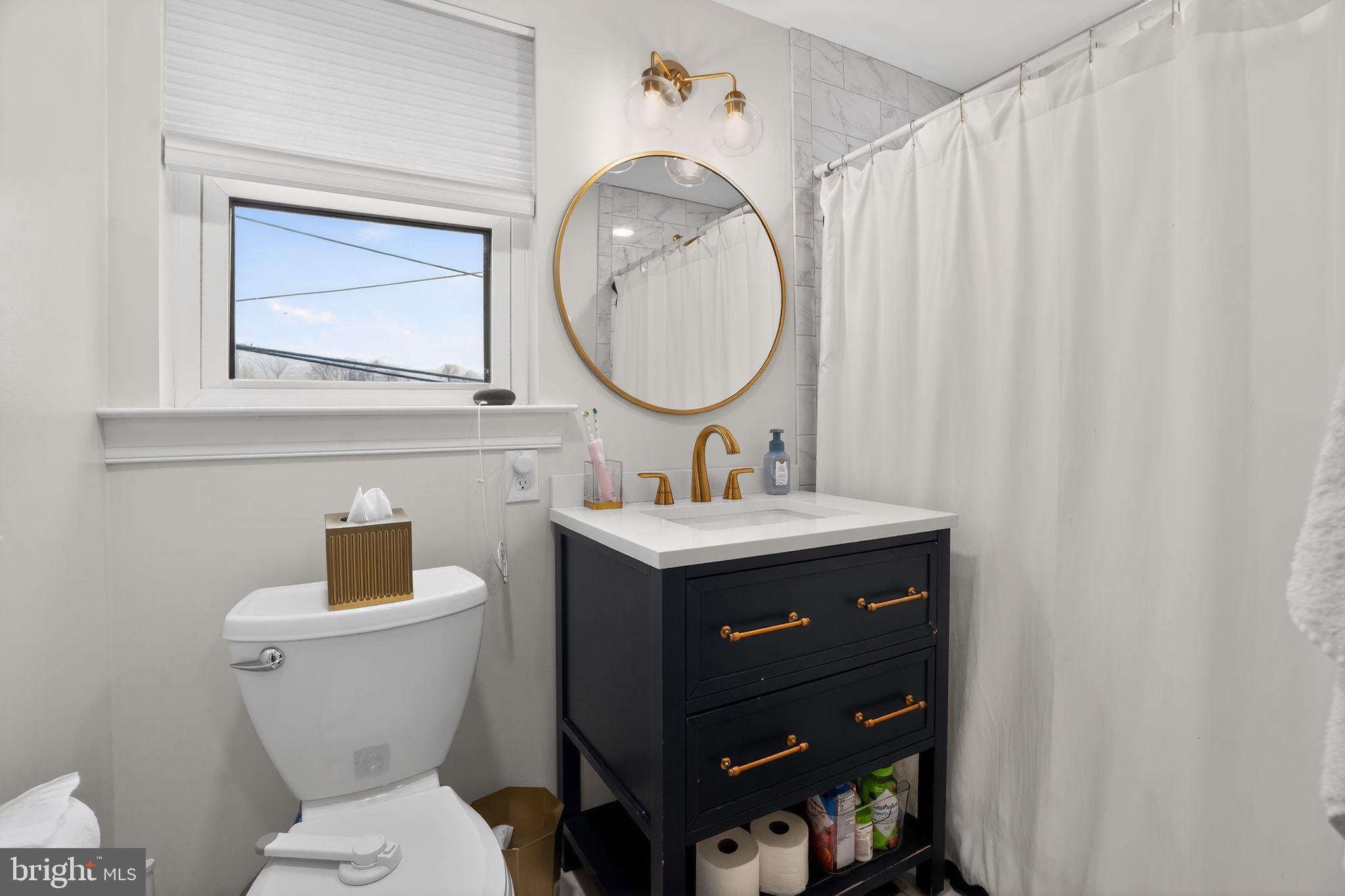 516 Church Road Norristown, PA 19403 - Photo 26 of 31 a bathroom with a toilet sink and mirror