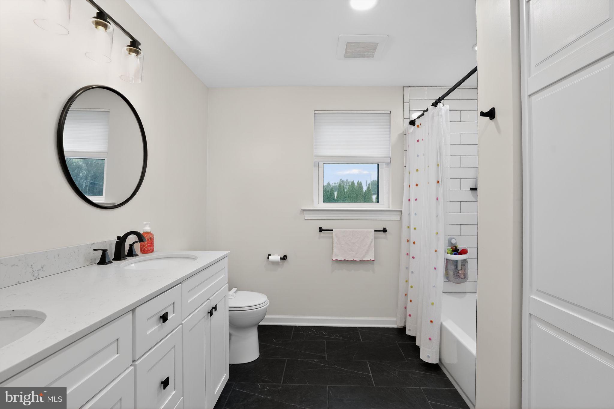 516 Church Road Norristown, PA 19403 - Photo 30 of 31 a bathroom with a double vanity sink toilet and shower
