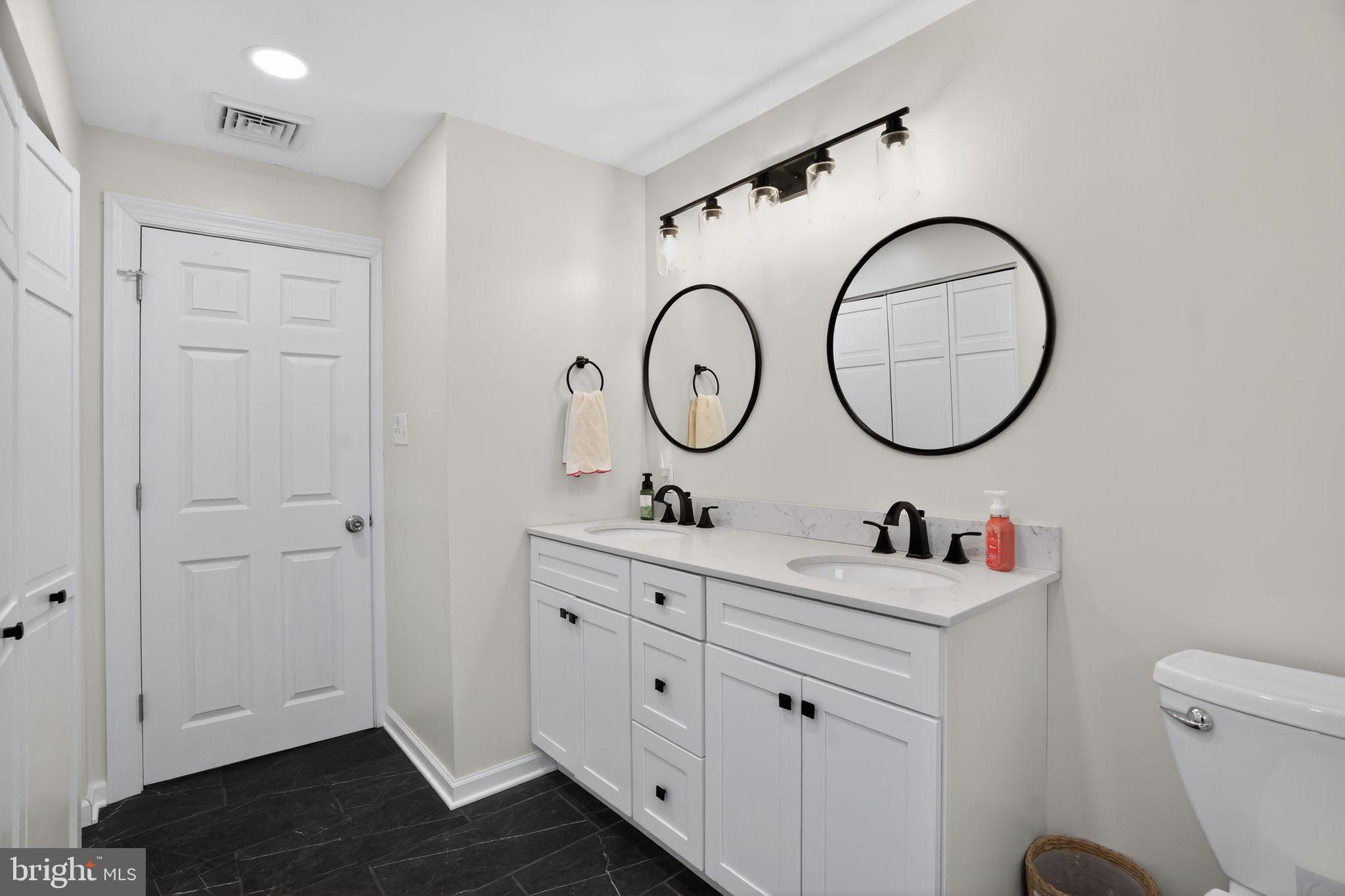 516 Church Road Norristown, PA 19403 - Photo 31 of 31 a bathroom with a toilet a sink and a mirror