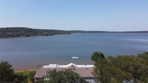 an aerial view of a house with a lake view