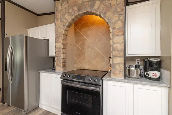a kitchen with a stove and a refrigerator