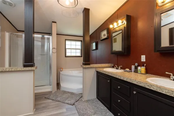 a spacious bathroom with a granite countertop sink a toilet and a mirror