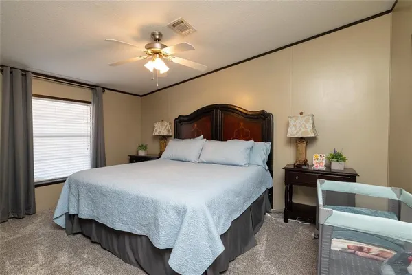a bedroom with a bed and a chandelier