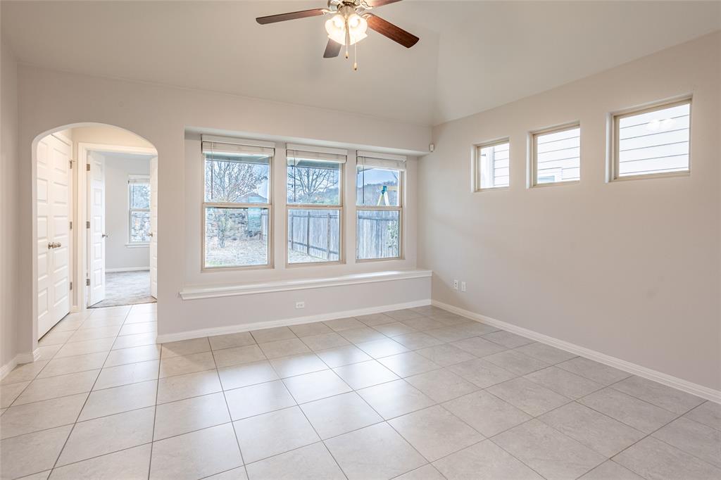 615 Stampede Road San Marcos, TX 78666 - Photo 15 of 26 A well-lit interior space features a graceful arched doorway, elevated ceilings, and ample natural light.