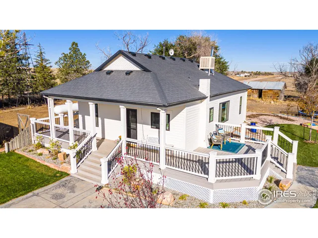 a balcony with table and chairs