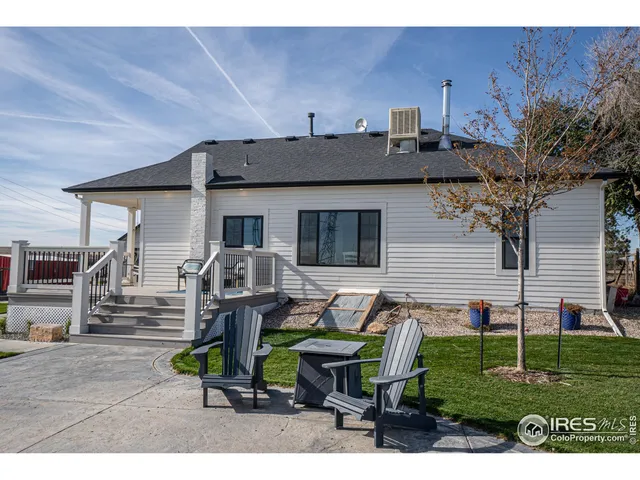 a backyard of a house with table and chairs