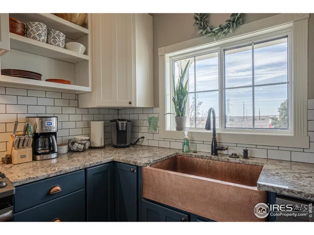 a kitchen with granite countertop a sink and a counter top space