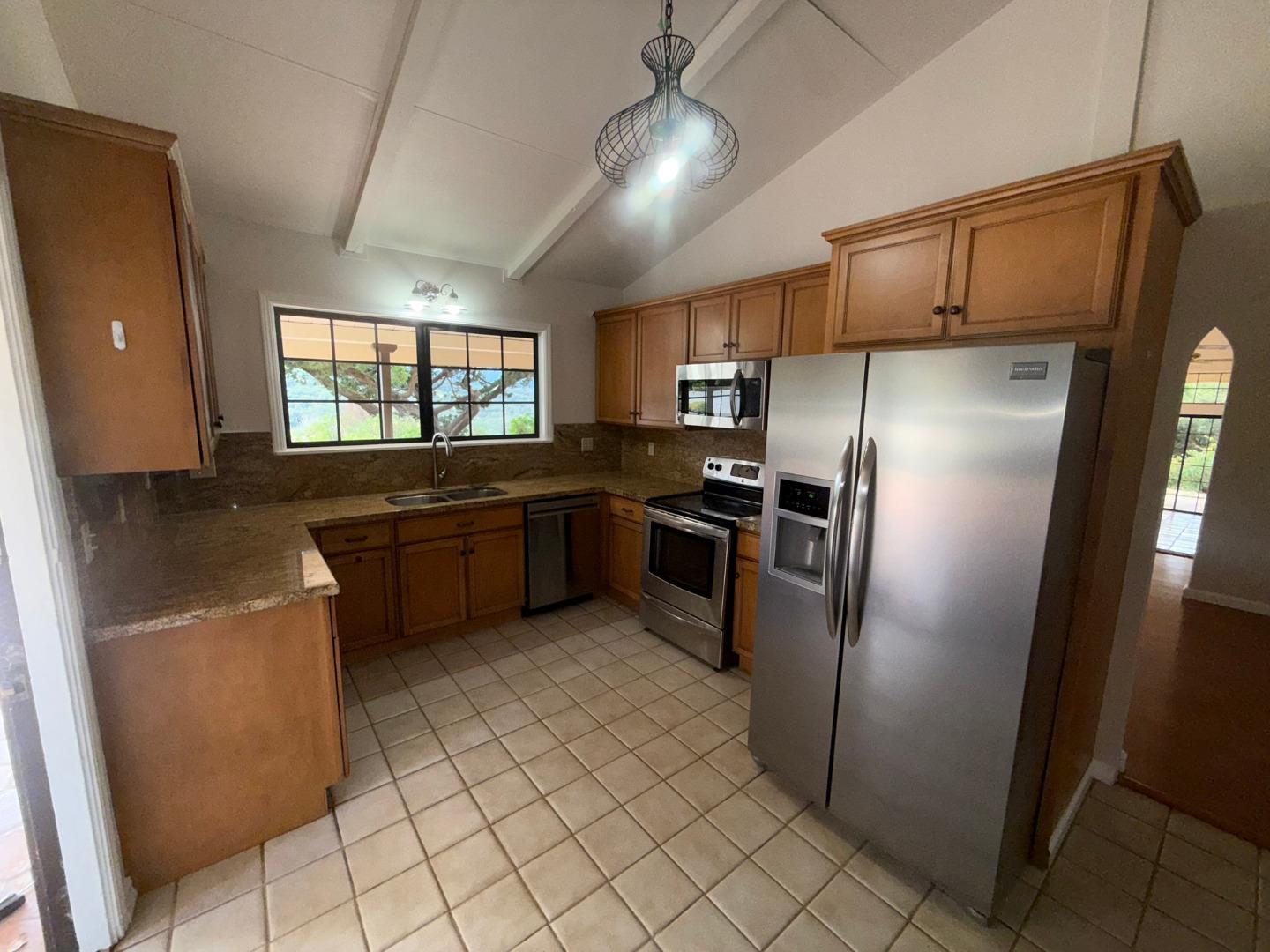 11585 McCarthy Road Carmel Valley, CA 93924 - Photo 22 of 52 a kitchen with granite countertop a refrigerator and a sink