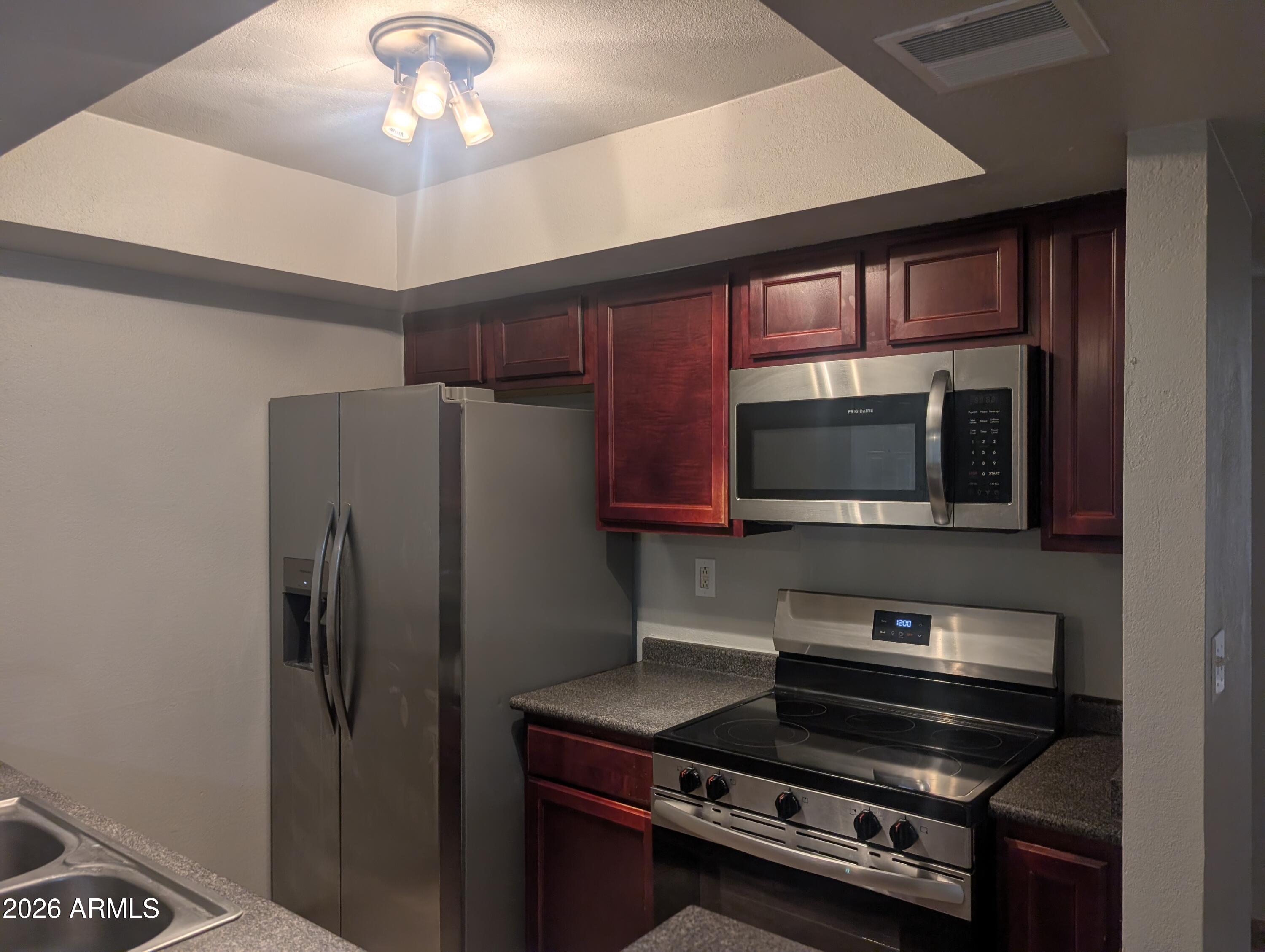 540 North May, Unit 1101 Mesa, AZ 85201 - Photo 1 of 15 Cherry cabinets with all appliances
