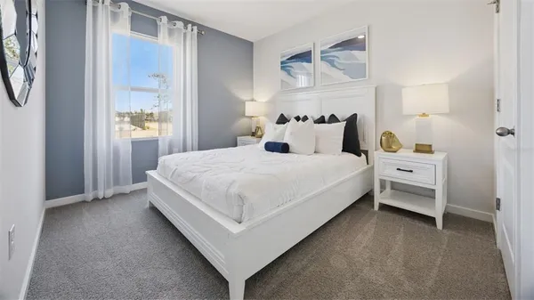 a large white bed in a white room