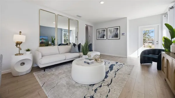 a living room with furniture and wooden floor