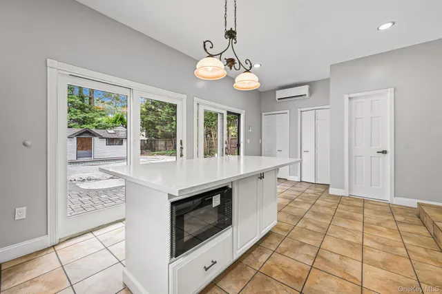a kitchen with a stove oven and a window