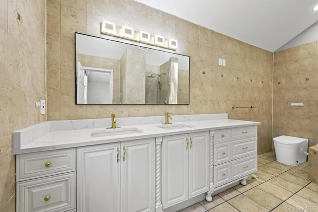 a bathroom with a double vanity sink and a mirror