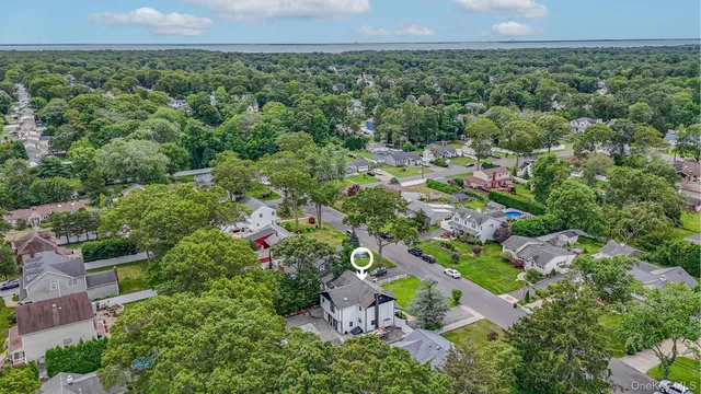 an aerial view of a houses with a yard