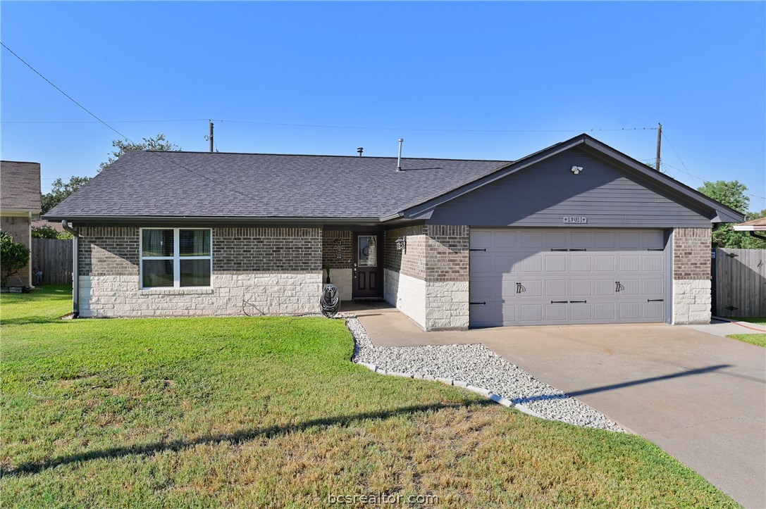 a front view of a house with a garden and yard