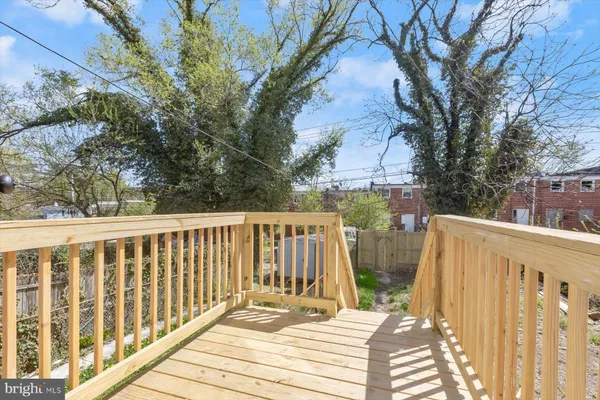 a view of balcony with wooden floor and fence