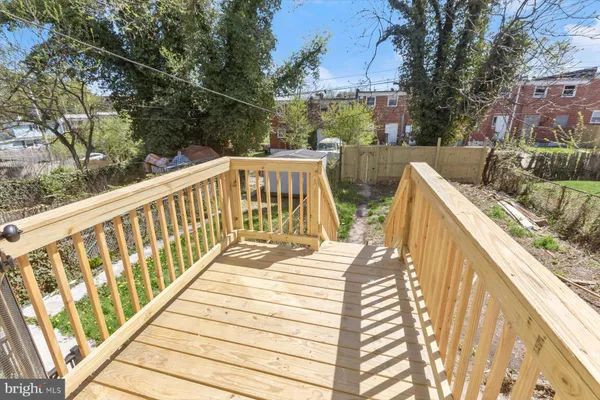a view of balcony with wooden floor and seating space