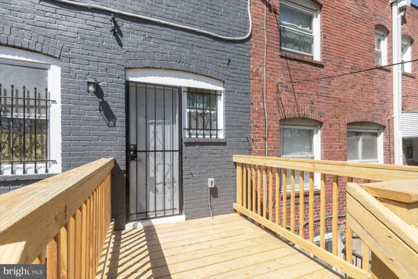 a view of a brick house with large windows