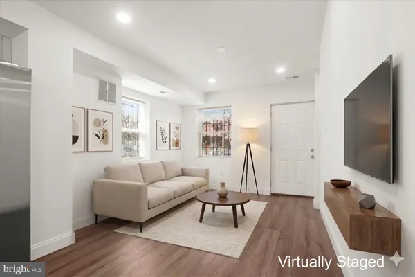 a living room with furniture and a flat screen tv